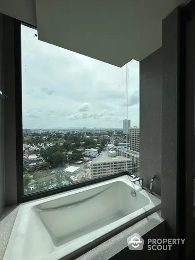 Luxurious bathroom with stunning city view from large window