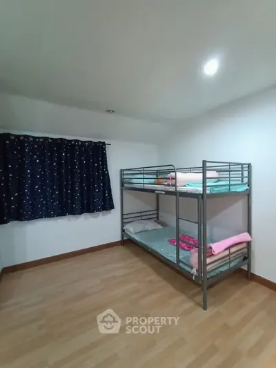 Cozy bedroom with bunk beds and starry curtains, perfect for maximizing space in a modern home.