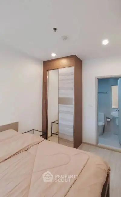 Modern bedroom with ensuite bathroom and sleek wardrobe design