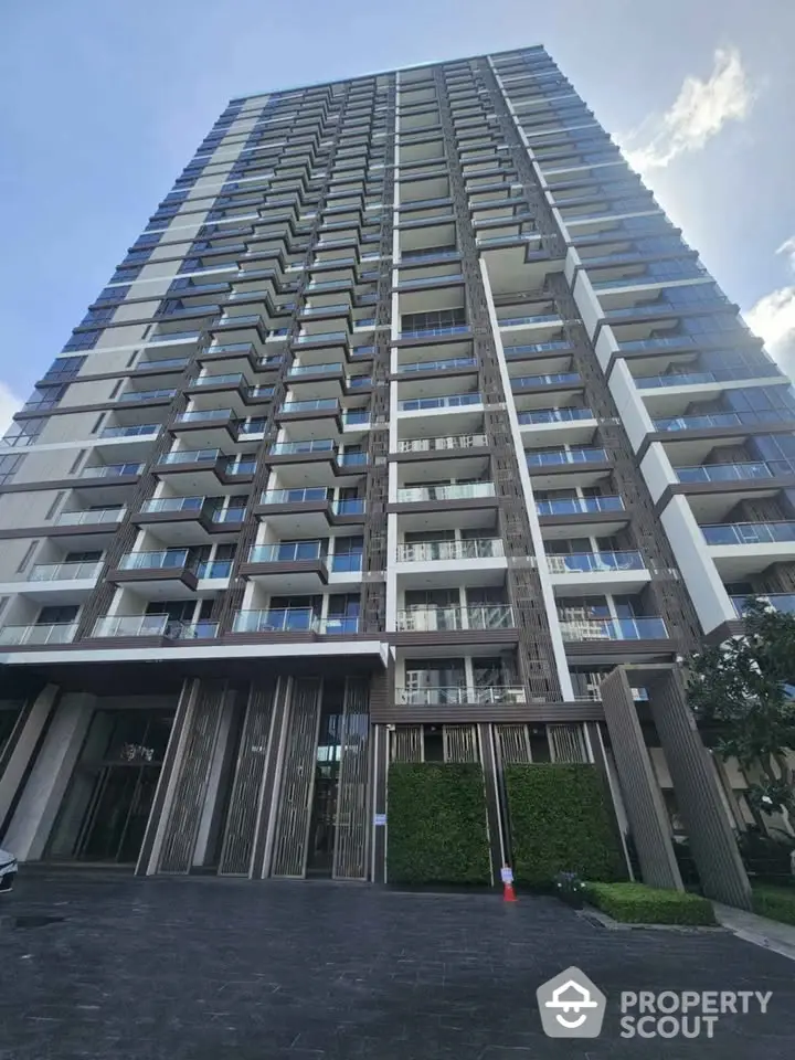 Modern high-rise building with multiple balconies and sleek design