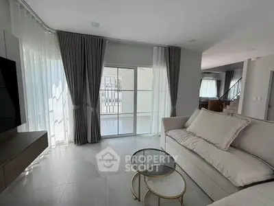 Elegant living room with modern decor, large windows, and stylish furniture in a contemporary home.