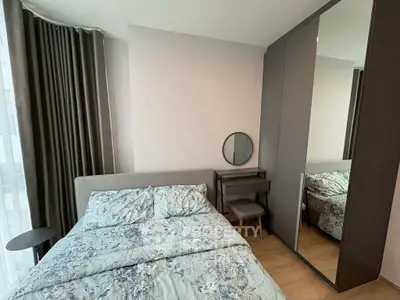Modern bedroom with stylish decor and mirrored wardrobe