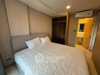 Cozy bedroom with modern design and ample storage in a stylish apartment.
