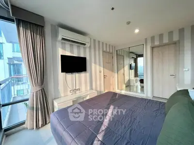 Modern bedroom with large window and stylish decor in a high-rise apartment.