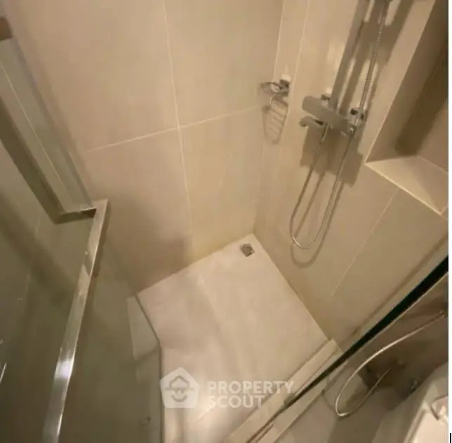 Modern bathroom with sleek shower design and glass door enclosure.