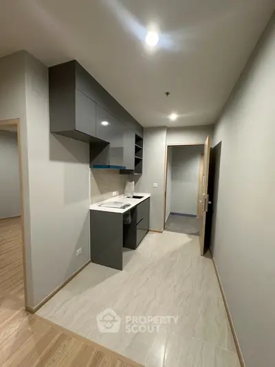 Modern compact kitchen with sleek cabinetry and neutral tones