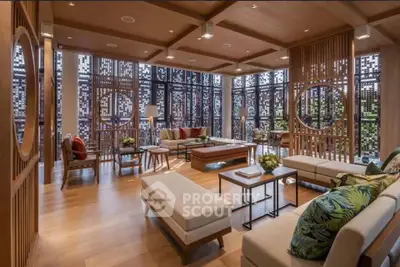 Luxurious living room with modern decor and large windows offering natural light.