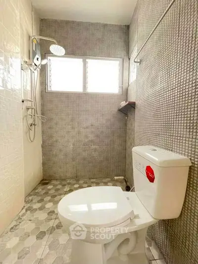 Modern bathroom with stylish tiles and shower area