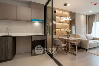Modern open-plan living room and kitchen with stylish decor and natural light.