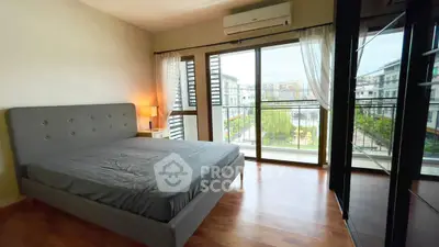 Spacious bedroom with balcony view in modern apartment