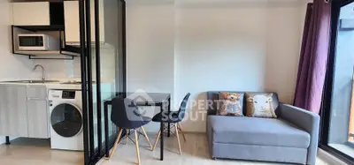 Modern studio apartment with compact kitchen and cozy living area