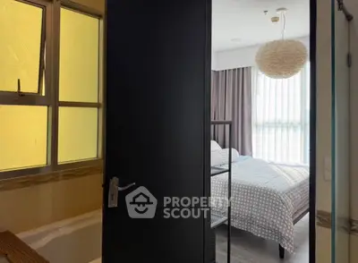 Cozy bedroom with modern decor and adjacent bathroom view