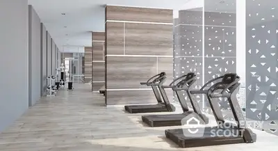 Modern gym with treadmills and stylish decor in luxury apartment building