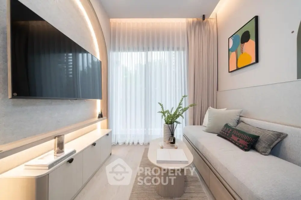 Modern living room with sleek design, featuring a large wall-mounted TV, stylish sofa, and elegant decor.