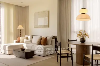 Elegant living room with modern decor, featuring a cozy sofa, stylish dining area, and warm lighting.