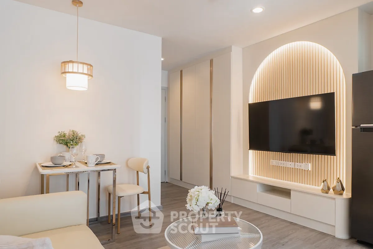 Modern living room with stylish decor and built-in TV unit, perfect for cozy urban living.