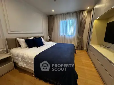 Luxurious bedroom with elegant decor and cozy ambiance, featuring a plush bed and stylish furnishings.