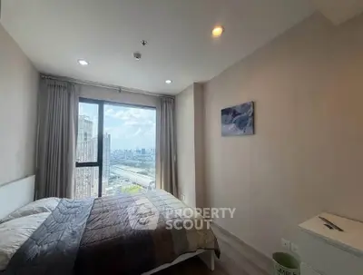 Modern bedroom with city view in high-rise apartment