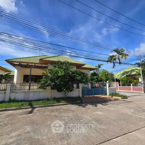 Charming suburban house with green roof and lush garden, perfect for family living.