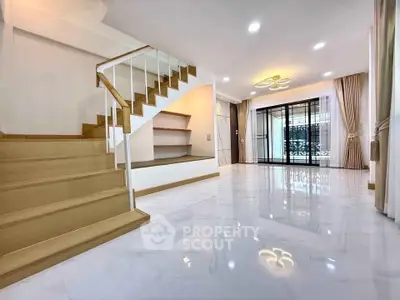 Spacious modern living room with elegant staircase and glossy flooring