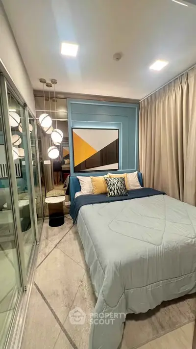 Modern bedroom with stylish decor, large mirror closet, and elegant lighting in a cozy apartment.