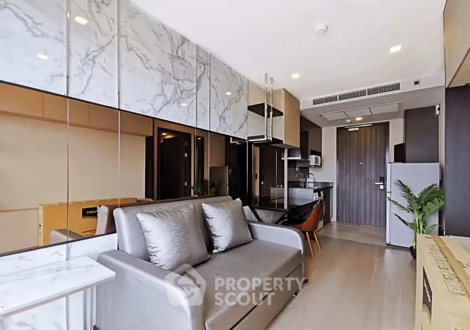 Modern living room with sleek design and open kitchen layout in a stylish apartment.
