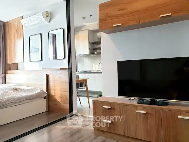 Modern studio apartment with open layout, featuring a cozy bedroom and stylish living area with wooden accents.