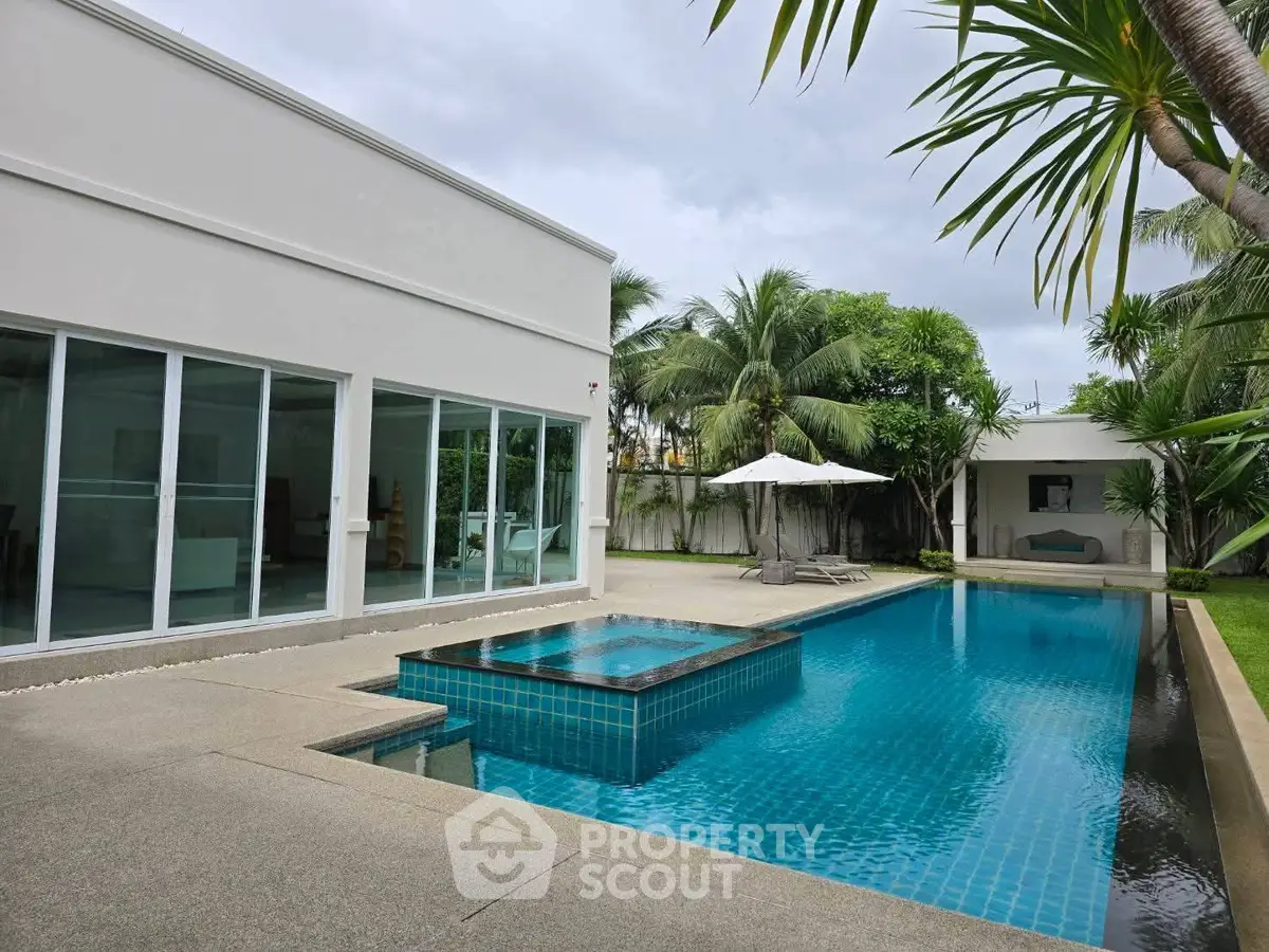 Luxurious villa with private pool and lush garden, perfect for tropical living.