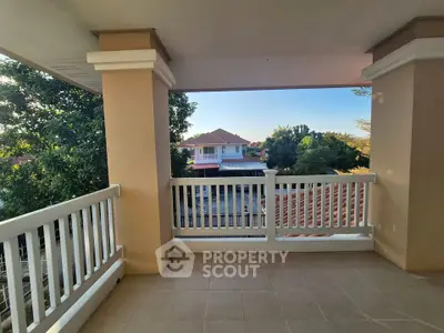 Spacious balcony with scenic view of suburban homes and lush greenery.
