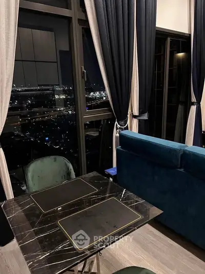 Luxurious high-rise living room with stunning night city view and elegant decor.