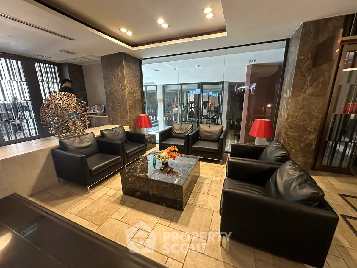 Luxurious lobby with modern leather seating and elegant decor in a high-end building.