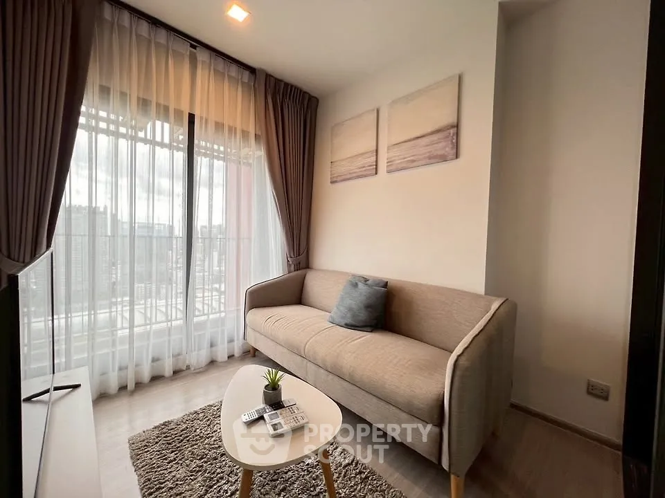 Cozy living room with modern sofa and large window offering city view