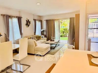 Spacious and elegant living room with modern decor and garden view, perfect for relaxation and entertaining.