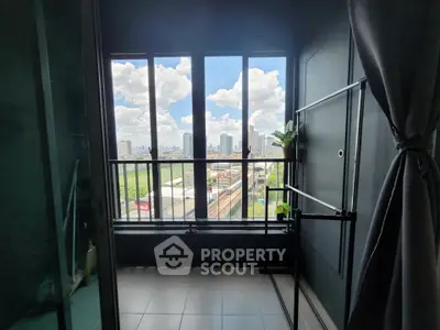 Stunning city view from a modern balcony with large windows and sleek design.