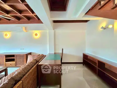 Spacious living room with modern wooden furniture and stylish ceiling design.