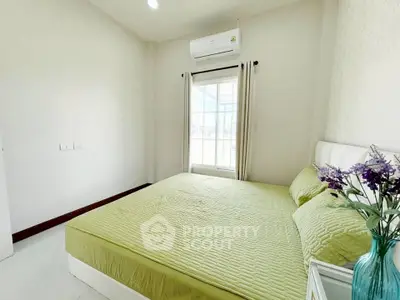 Bright and cozy bedroom with green bedding and natural light