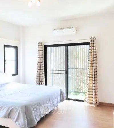 Bright and airy bedroom with large windows and modern decor