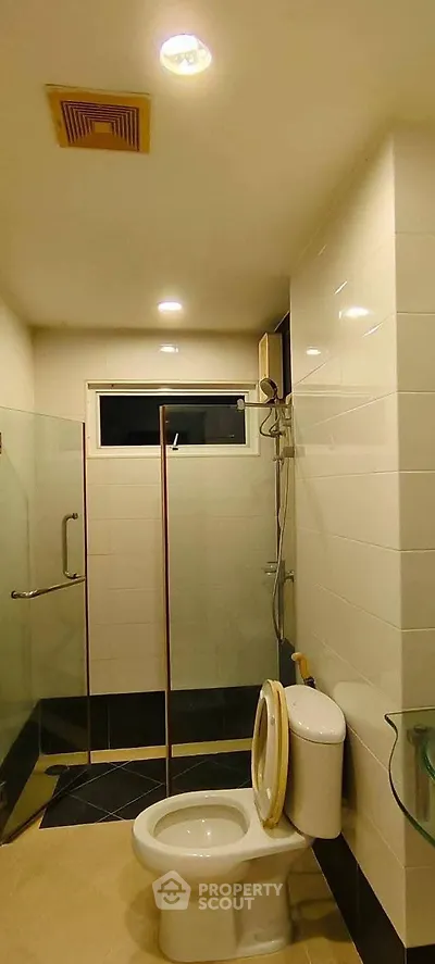 Modern bathroom with glass shower enclosure and sleek fixtures