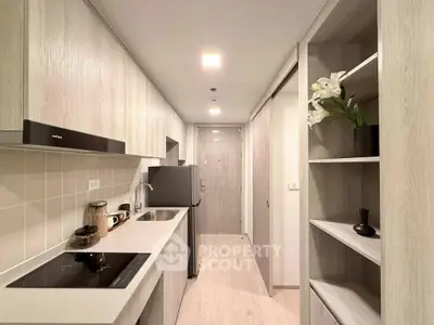 Modern kitchen with sleek cabinetry and built-in appliances in a stylish apartment.