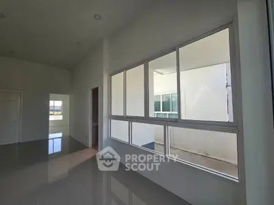 Spacious modern interior with large windows and glossy floors