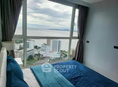 Stunning bedroom with panoramic ocean view in high-rise apartment