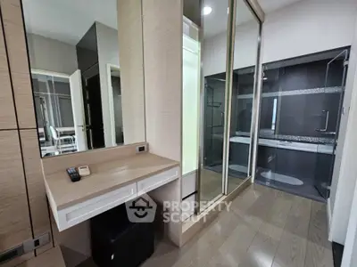 Modern bathroom with sleek glass shower and wooden vanity in luxury apartment