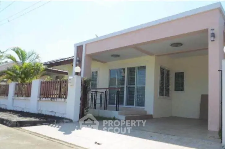 Charming single-story home with spacious driveway and modern facade in a serene neighborhood.