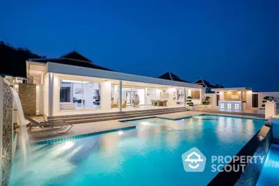 Luxurious modern villa with stunning pool and elegant outdoor lighting at dusk.