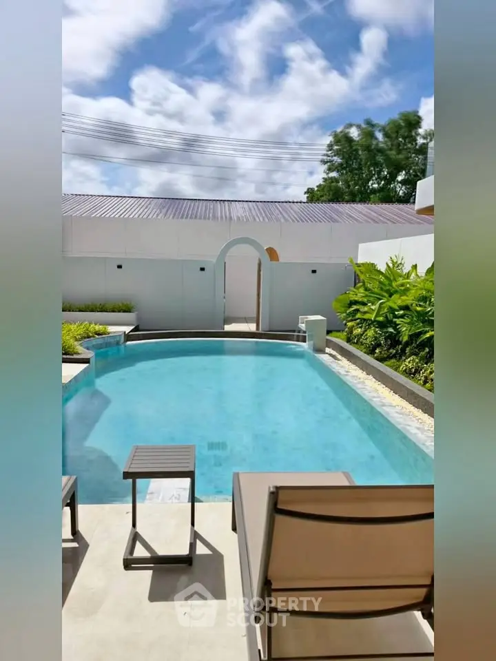 Luxurious private pool area with modern design and lush greenery, perfect for relaxation and entertainment.