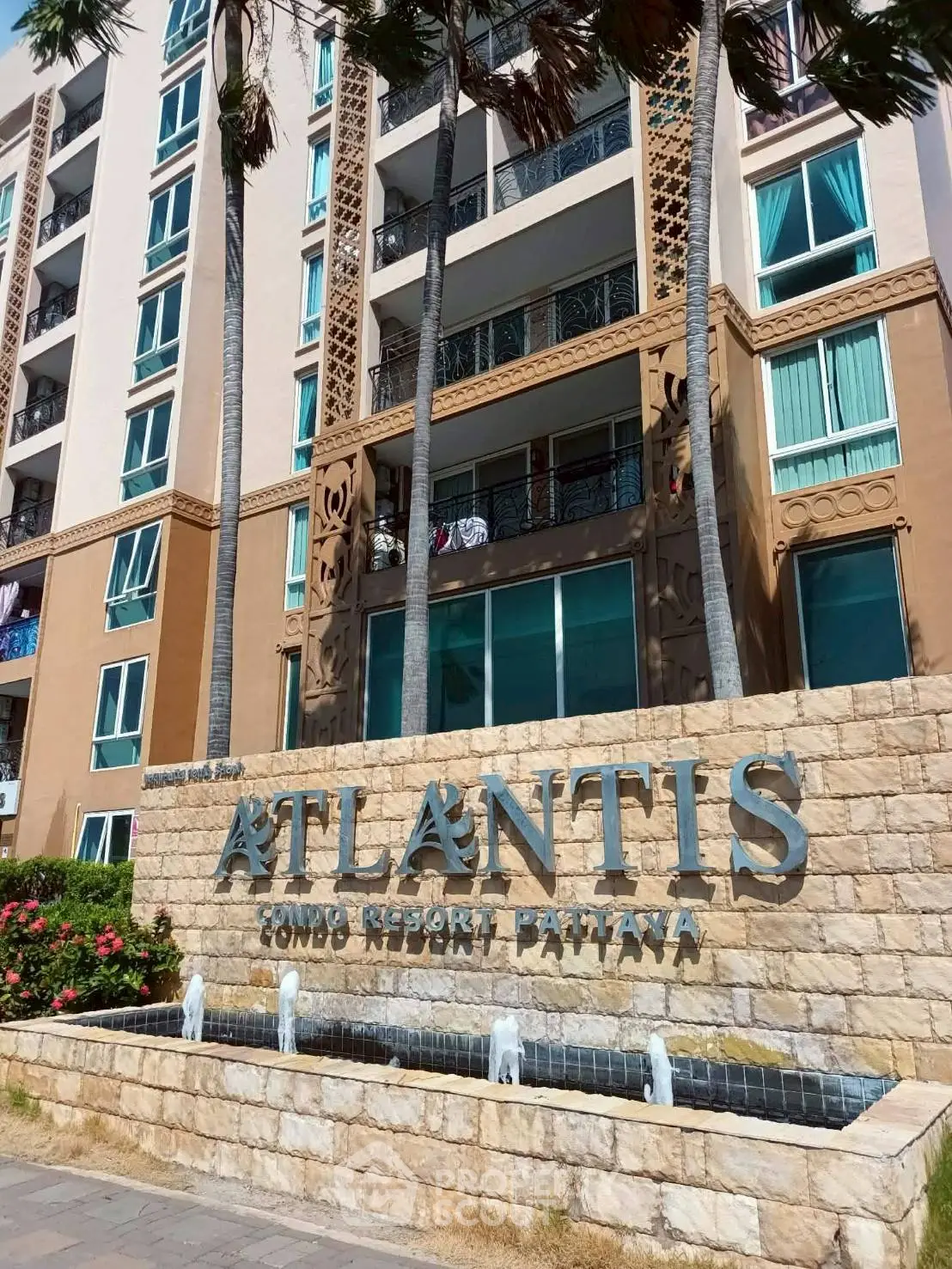 Modern condo resort exterior with elegant facade and lush landscaping