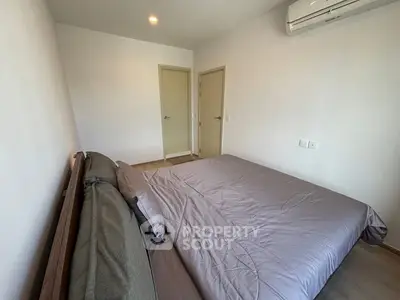 Modern bedroom with minimalist design and air conditioning unit