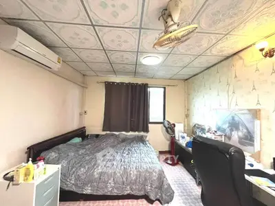 Cozy bedroom with air conditioning and ceiling fan, featuring a comfortable bed and ample natural light.