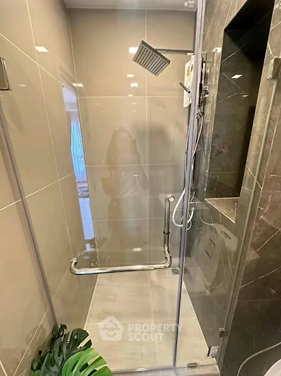 Modern bathroom with sleek glass shower enclosure and stylish fixtures