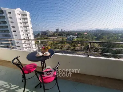 Stunning balcony with breathtaking city view and cozy seating area